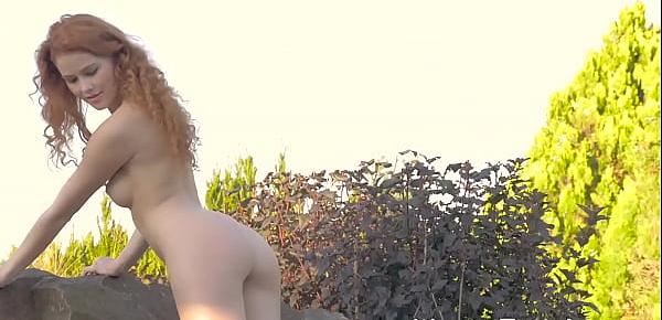  Young redhead sensually teasing in nature